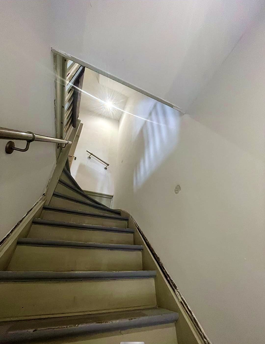 Escalier à Dunkerque après travaux, murs blancs et marches peintes